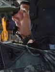 Sgt. 1st Class Scott P. Campbell selects a radio to privately instruct a crew member during flight. Photo courtesy U.S. ...